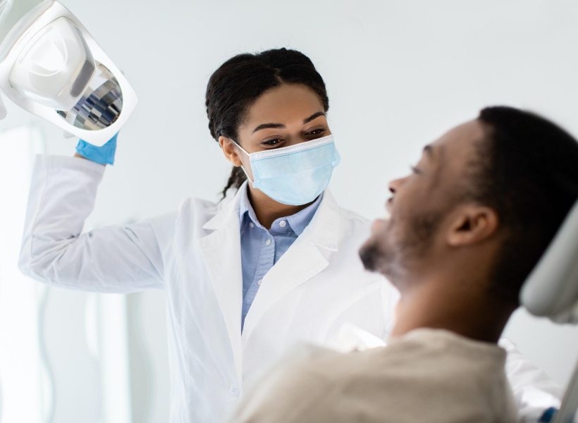 Dentistry Concept. Young Black Patient Guy Having Check Up With Dentist Woman